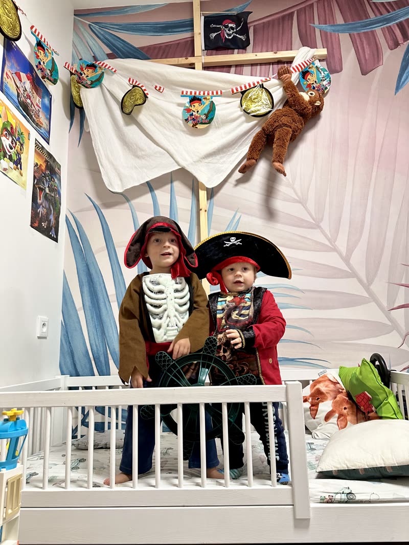 My two sons dressed as pirates in their bed